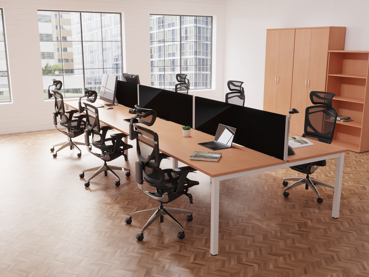 A modern office setup featuring a long desk with four workstations